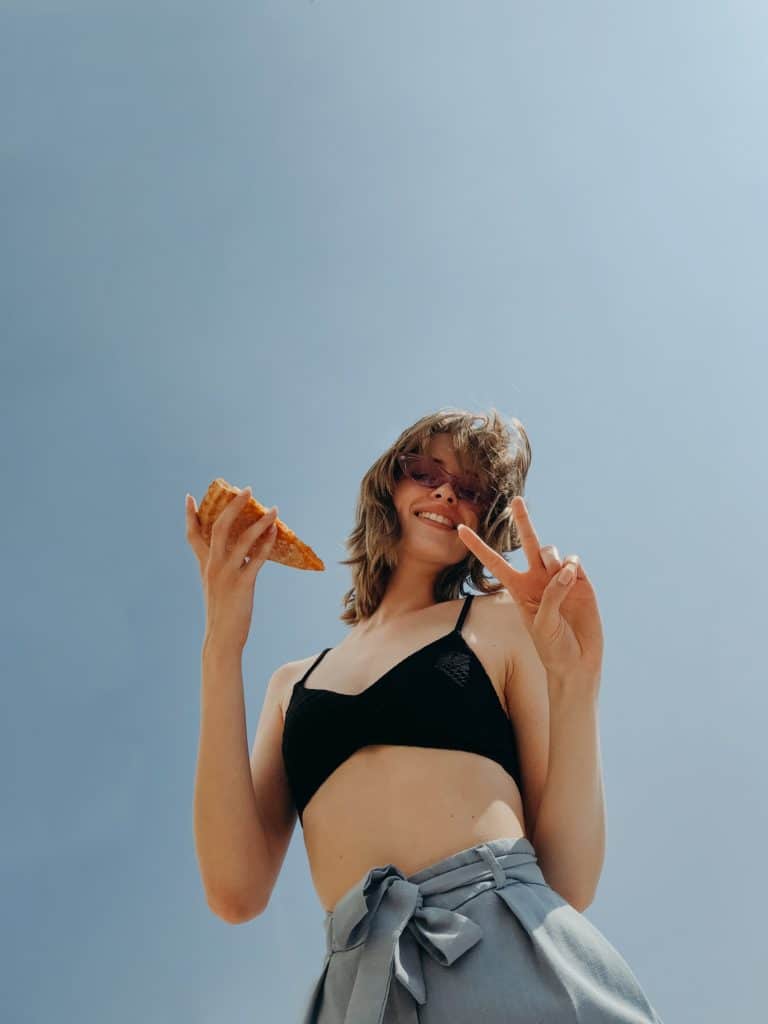 Woman holding pizza slice